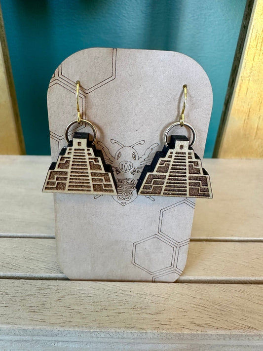 Natural colored wood chichen itza pyramid temple earrings on a gold colored hypoallergenic earring hook. Earrings on a brown card stock earring holder. 