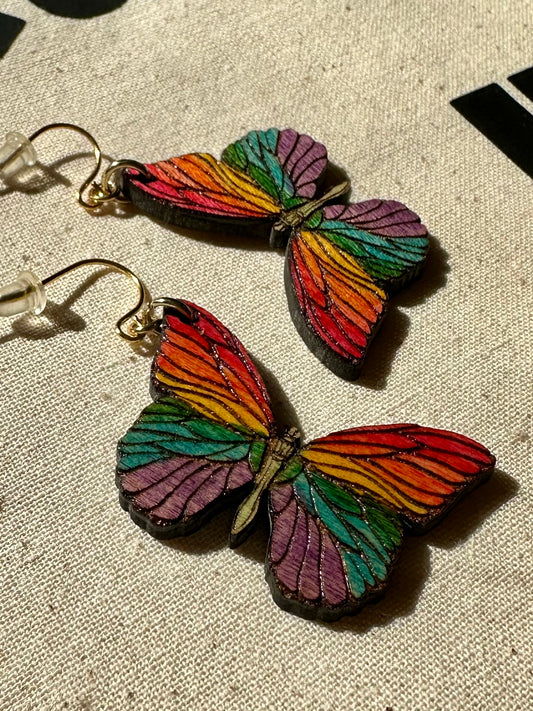 wood engraved rainbow butterfly earrings with gold colored hypoallergenic earring hooks.