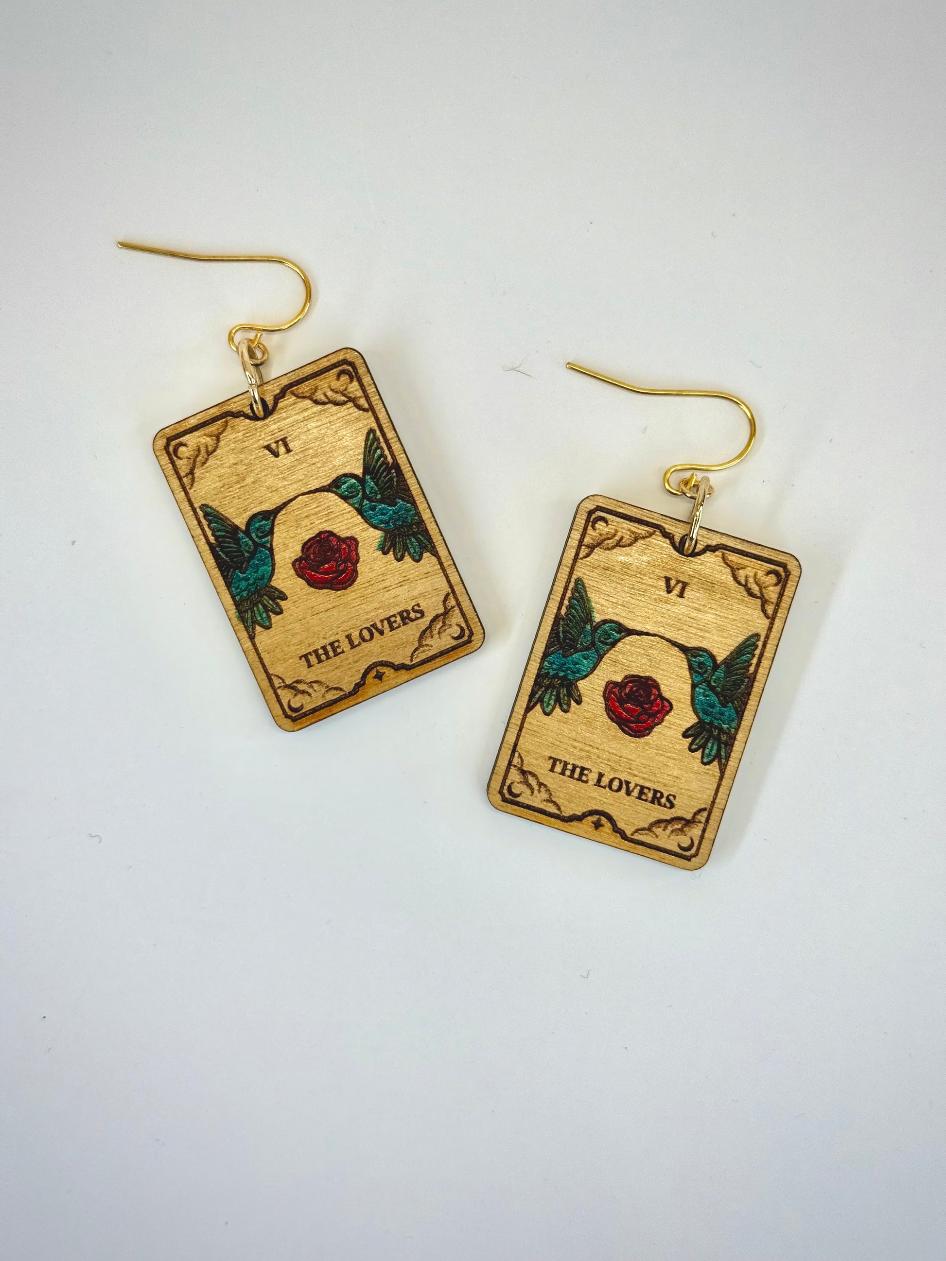 Wooden tarot card earrings with 'The Lovers' design on a white background